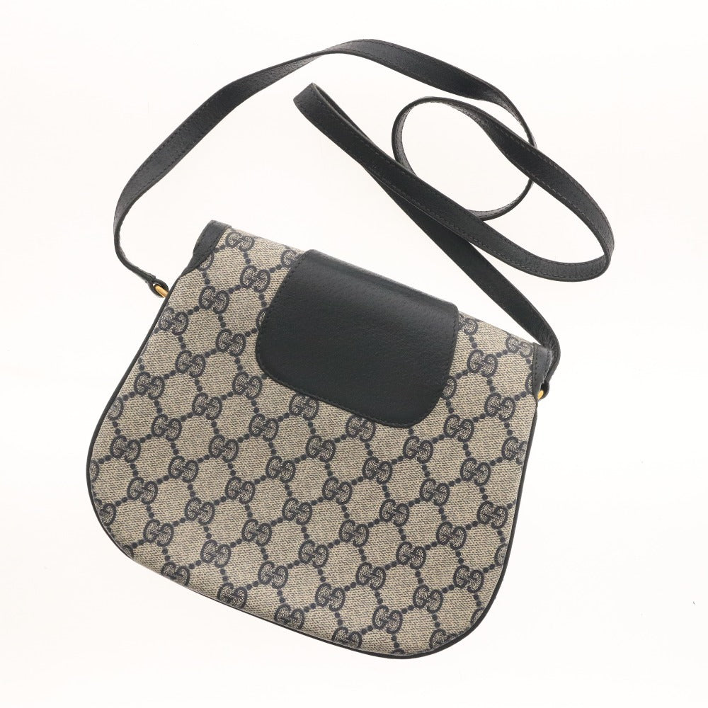 ■ Vintage Gucci shoulder bag with GG Supreme horsebit detail and gold hardware. Women's dark navy.