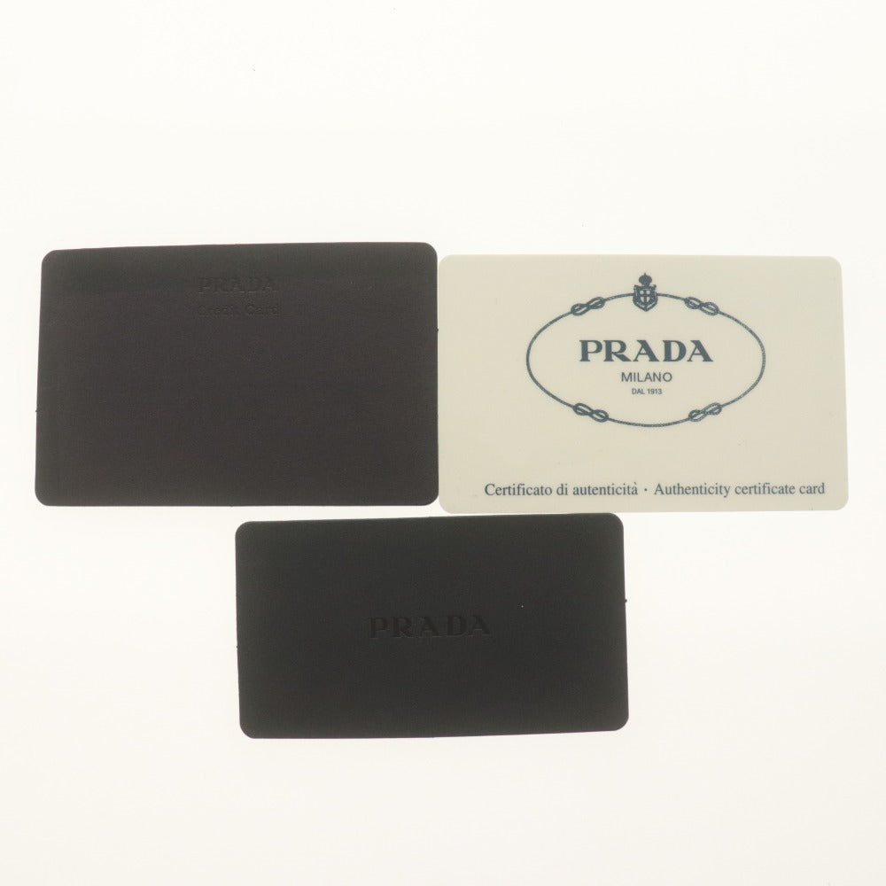 ■ PRADA プラダ 二つ折り財布 サフィアーノレザー コンパクト ラウンドジップ 三角ロゴ 小銭入れ付 メンズ レディース ブラック 付属品付
